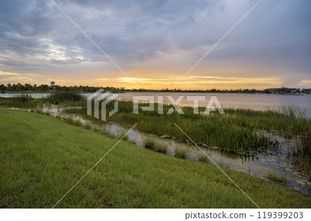 Sunset landscape in Wellen park in North Port, Florida. Beautiful lake nature in evening Sunset landscape in Wellen park in North Port, Florida. Beautiful lake nature in evening 119399203