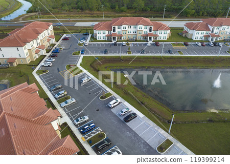 Top view of new apartment condos in Florida suburban area. Family housing in quiet neighborhood. Real estate development in american suburbs Top view of new apartment condos in Florida suburban area. Family housing in quiet neighborhood. Real estate development in american suburbs 119399214