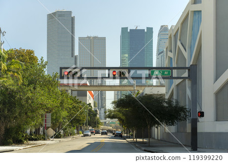 Traffic lights regulating driving cars on city street in Miami, Florida 119399220