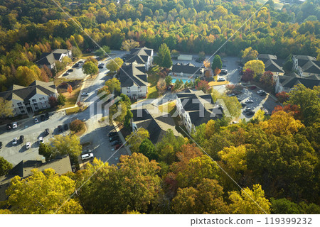 View from above of apartment residential condos between yellow fall trees in suburban area in South Carolina. American homes as example of real estate development in US suburbs View from above of apartment residential condos between yellow fall trees in suburban area in South Carolina. American homes as example of real estate development in US suburbs 119399232