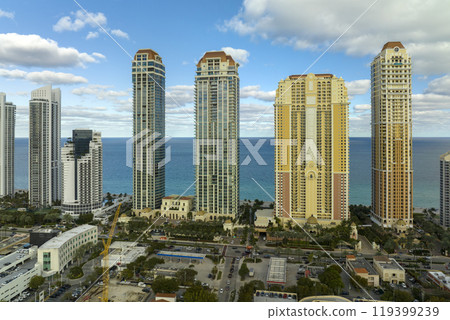 View from above of luxurious highrise hotels and condos on Atlantic ocean shore in Sunny Isles Beach city. American tourism infrastructure in southern Florida View from above of luxurious highrise hotels and condos on Atlantic ocean shore in Sunny Isles Beach city. American tourism infrastructure in southern Florida 119399239