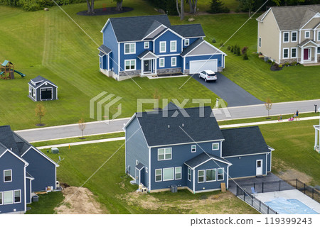 View from above of residential houses in living area in Rochester, NY. American dream homes as example of real estate development in US suburbs View from above of residential houses in living area in Rochester, NY. American dream homes as example of real estate development in US suburbs 119399243