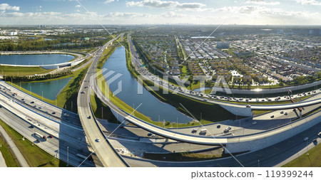 View from above of USA transportation infrastructure. Aerial view of american freeway intersection with fast driving cars and trucks in Miami, Florida View from above of USA transportation infrastructure. Aerial view of american freeway intersection with fast driving cars and trucks in Miami, Florida 119399244