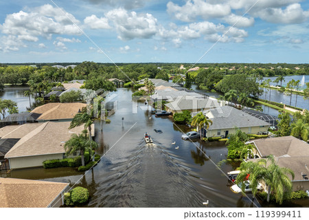 Hurricane Debby flooded street in Sarasota, Florida. Victims boating on rainfall flood waters between rural homes in residential area Hurricane Debby flooded street in Sarasota, Florida. Victims boating on rainfall flood waters between rural homes in residential area 119399411