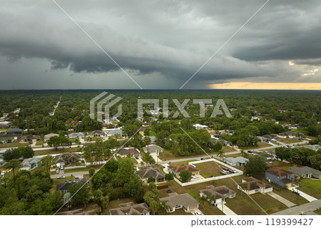 Landscape of dark ominous clouds forming on stormy sky before heavy thunderstorm over rural town area 119399427