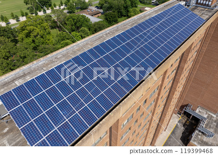 Photovoltaic panels on solar rooftop of condo building for producing clean ecological electrical energy. Renewable electricity with zero emission concept 119399468