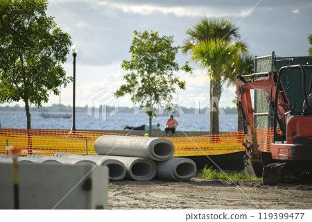 Protective restriction barrier at industrial construction site. Safety mesh fence for pedestrians 119399477