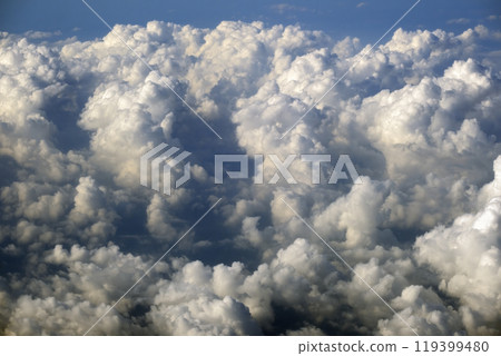 Rain clouds forming at high altitude. View from plane window at high altitude of sky. Air travel concept 119399480