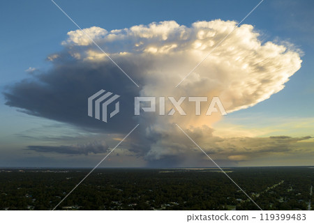 Rainstorm shower over Florida rural town in humid summer season. Rain water pouring down from stormy clouds 119399483