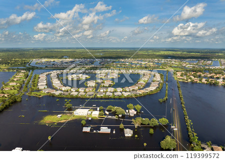 Flooded farmland area with underwater buildings from hurricane rainfall water in Florida rural community. Aftermath of natural disaster in southern USA 119399572
