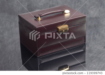 Brown leather case for storing various jewelry with a small box for a ring. 119399743