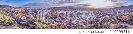 Drone panorama of Tbilisi, Georgia, with the Kura River at sunrise showcasing the cityscape 119399816