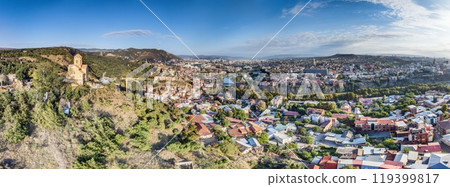Drone panorama of Tbilisi, Georgia, with the Kura River at sunrise showcasing the cityscape 119399817