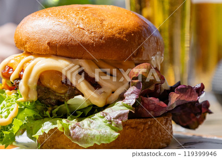 Gourmet burger served with fresh greens, generous amount of sauce Gourmet burger served with fresh greens, generous amount of sauce 119399946