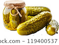 A jar of pickles sits next to three pickles. AI Generative 119400537