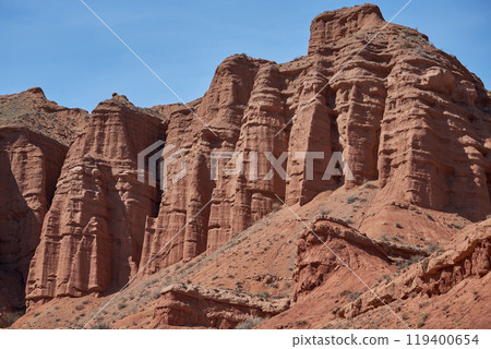 Sheer cliffs erosion subject, red rocks, canyon, travel destination Kyrgyzstan 119400654
