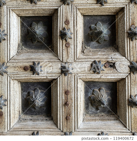 fragment of antique old door made of wood and metal with floral pattern fragment of antique old door made of wood and metal with floral pattern 119400672