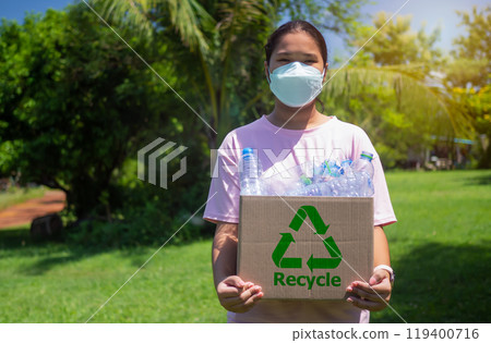Woman collecting garbage and holding a recycle bin with plastic bottles in the outdoors, Recycle concept, Plastic-free, Junk food plastic packaging, Reduction environmental pollution. 119400716