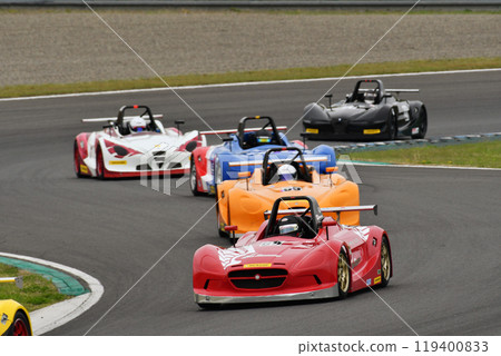 A racing car racing through an S-shaped corner A racing car racing through an S-shaped corner 119400833