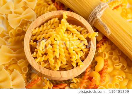 Pasta noodles for cooking Italian food in plastic bag on white background. 119401299