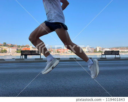 athlete running in shadows, city marathon race athlete running in shadows, city marathon race 119401843