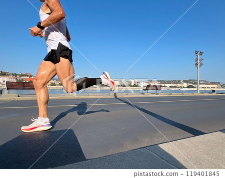 male runner running marathon, sweaty muscular athlete legs male runner running marathon, sweaty muscular athlete legs 119401845
