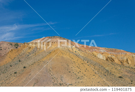 multi-colored sandstone mountain against the blue sky multi-colored sandstone mountain against the blue sky 119401875