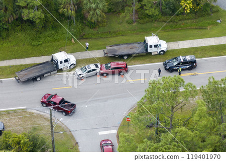 Car crash site with emergency services personnel and vehicles responding to accident on American street. First responders helping victims of vehicle collision on bridge road in USA Car crash site with emergency services personnel and vehicles responding to accident on American street. First responders helping victims of vehicle collision on bridge road in USA 119401970