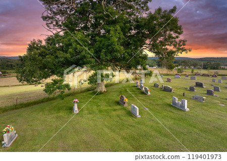 Church graveyard with many tombstones in small American town. Burial place on churchyard green grass Church graveyard with many tombstones in small American town. Burial place on churchyard green grass 119401973