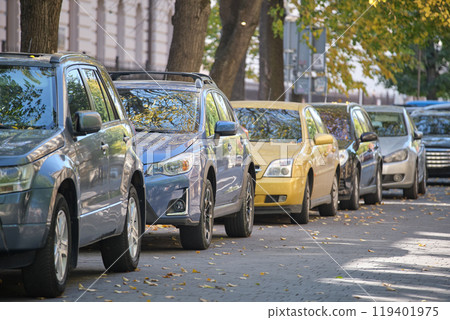 City traffic with many cars parked in line on street side City traffic with many cars parked in line on street side 119401975