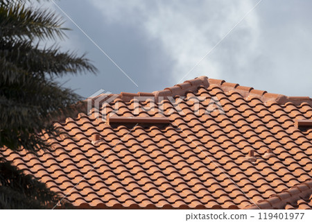 Closeup of house rooftop covered with ceramic shingles. Tiled covering of building Closeup of house rooftop covered with ceramic shingles. Tiled covering of building 119401977