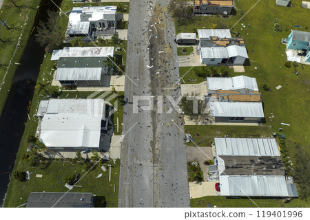 Consequences of natural disaster in Florida, USA. Aerial view of heavily damaged by hurricane Ian houses in mobile home residential area 119401996