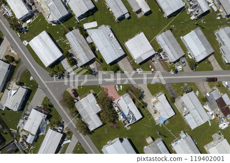 Consequences of natural disaster. Severely damaged houses after hurricane Ian in Florida mobile home residential area 119402001