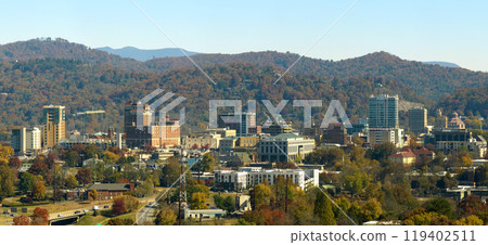 Aerial view of Asheville city in North Carolina with high buildings and mountain hills in distance 119402511