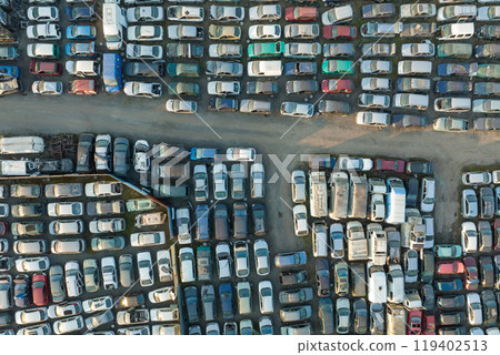 Aerial view of big parking lot of junkyard with rows of discarded broken cars. Recycling of old vehicles 119402513
