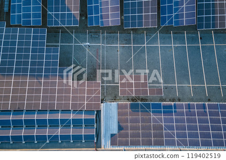 Aerial view of blue photovoltaic solar panels mounted on industrial building roof for producing green ecological electricity. Production of sustainable energy concept Aerial view of blue photovoltaic solar panels mounted on industrial building roof for producing green ecological electricity. Production of sustainable energy concept 119402519