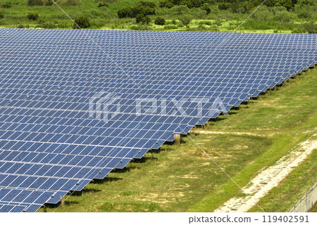 Aerial view of large sustainable electrical power plant with rows of solar photovoltaic panels for producing clean electric energy. Concept of renewable electricity with zero emission Aerial view of large sustainable electrical power plant with rows of solar photovoltaic panels for producing clean electric energy. Concept of renewable electricity with zero emission 119402591