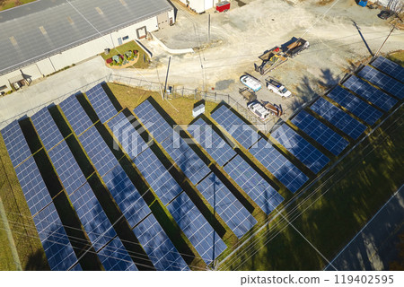 Aerial view of large sustainable electrical power plant with rows of solar photovoltaic panels for producing clean electric energy. Concept of renewable electricity with zero emission Aerial view of large sustainable electrical power plant with rows of solar photovoltaic panels for producing clean electric energy. Concept of renewable electricity with zero emission 119402595