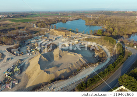 Aerial view of open pit mining of limestone materials for construction industry with excavators and dump trucks 119402606
