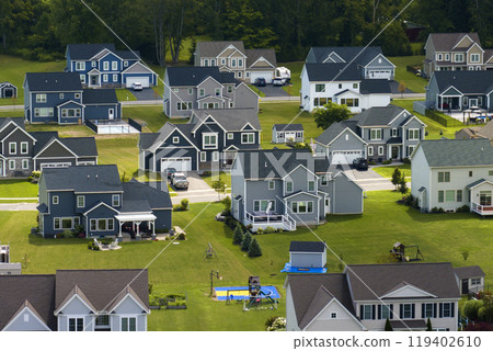 Aerial view of private residential houses in rural suburban sprawl area in Rochester, New York. Upscale suburban homes with large backyards and green grassy lawns in summer season 119402610