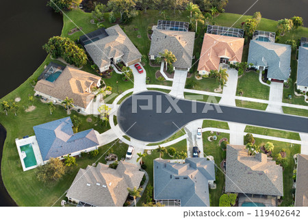 Aerial evening view of spacious family houses in Florida suburban area. Real estate development in American suburbs 119402642
