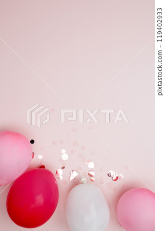 Birthday attributes colorful balloons and confetti. Concept of festive birthday celebrations 119402933