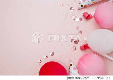 Birthday attributes colorful balloons, party hats and confetti. Concept of festive birthday celebrations 119402935