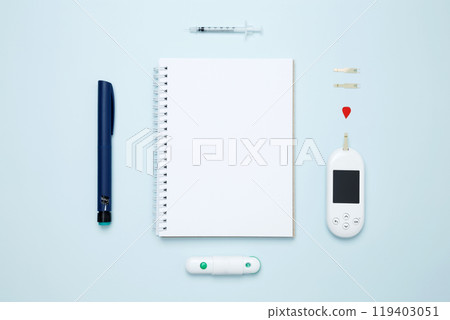 Diabetes concept with glucometer, syringe pen with insulin, blood test strips. Mock up white paper. Concept of worldwide diabetes awareness. 119403051