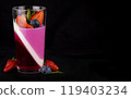 Fruit jelly with strawberries and blueberries in a glass on a black background, a beautiful dessert 119403234