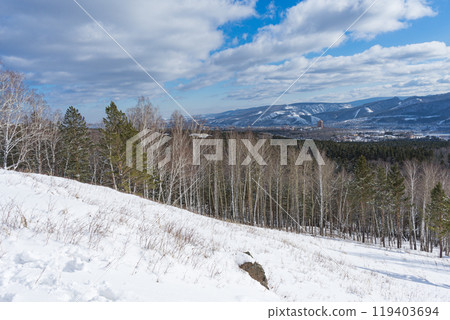 Winter landscape. Neighborhood of city and nature. Blue sky low white clouds 119403694