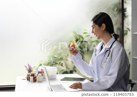 Female Doctor Providing Medical Advice with Medication in a Modern Office Setting 119403783