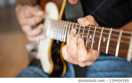 Man hand playing on electric guitar Man hand playing on electric guitar 119404380