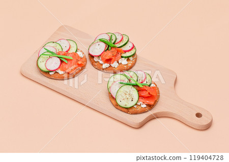Cracker Sandwiches with Salmon, Cucumber, Radish, Cottage Cheese and Green Onions Cracker Sandwiches with Salmon, Cucumber, Radish, Cottage Cheese and Green Onions 119404728