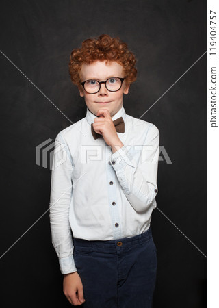 Handsome redhead young child boy shcool kid wearing white t-shirt thinking Handsome redhead young child boy shcool kid wearing white t-shirt thinking 119404757